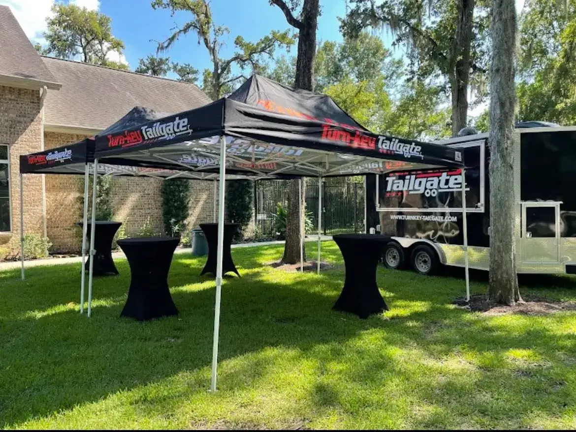 Tents and trailer in a backyard