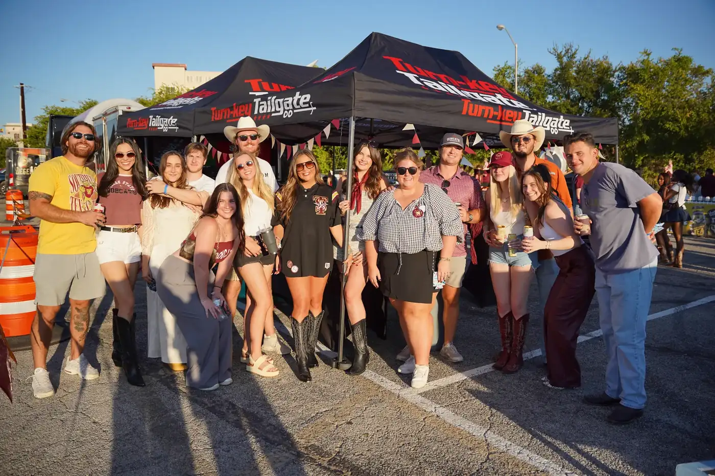 Wide view of a Turn-Key Tailgate event setup with tents, tables and a trailer